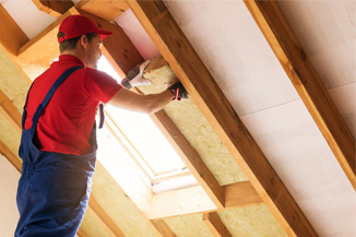 Men putting insulation on ceiling